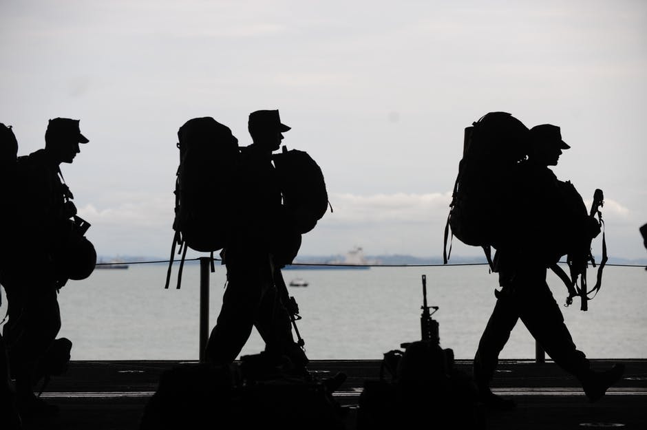 A photograph of three soldiers walking with guns