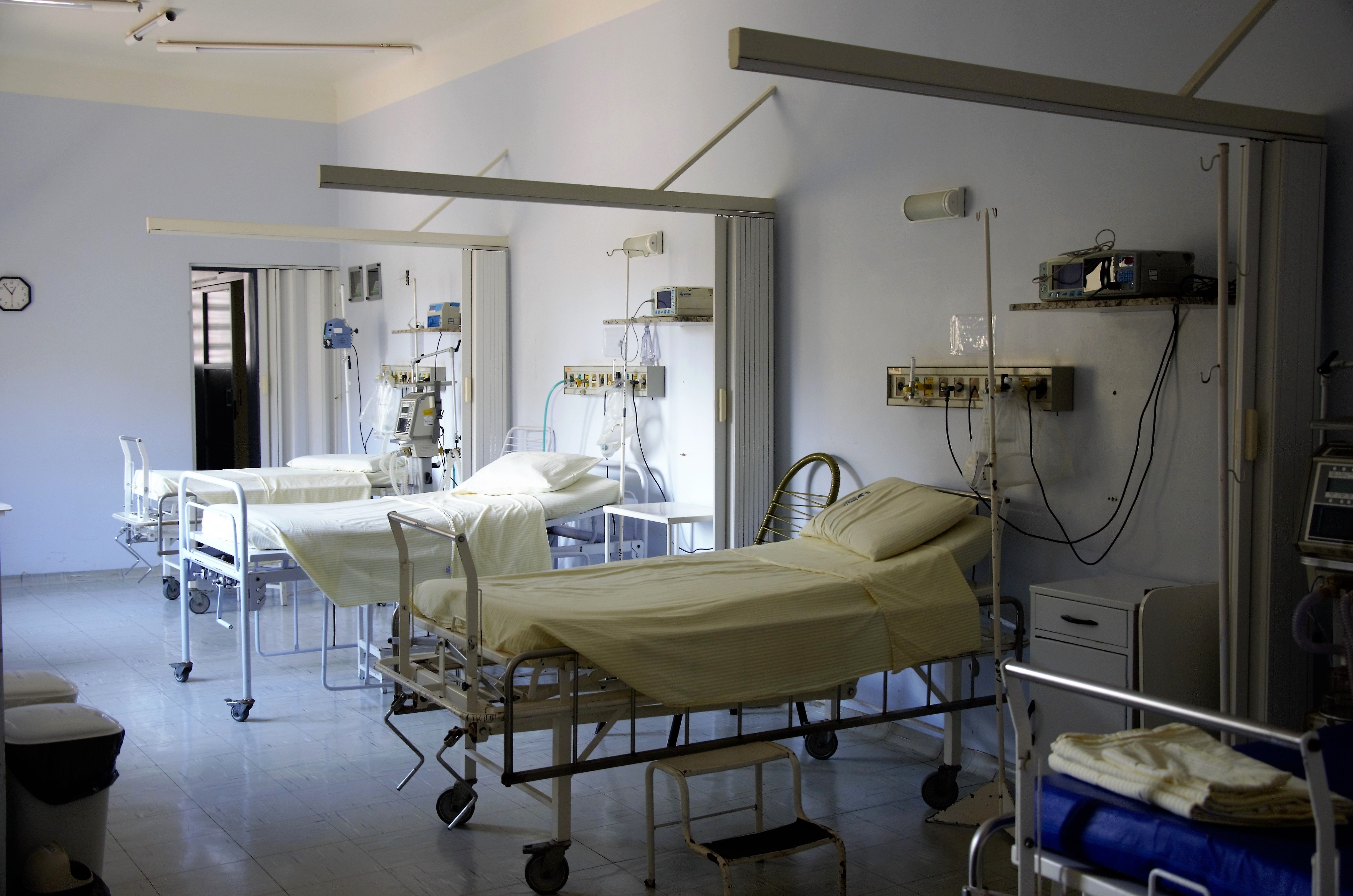 A photograph of three hospital beds