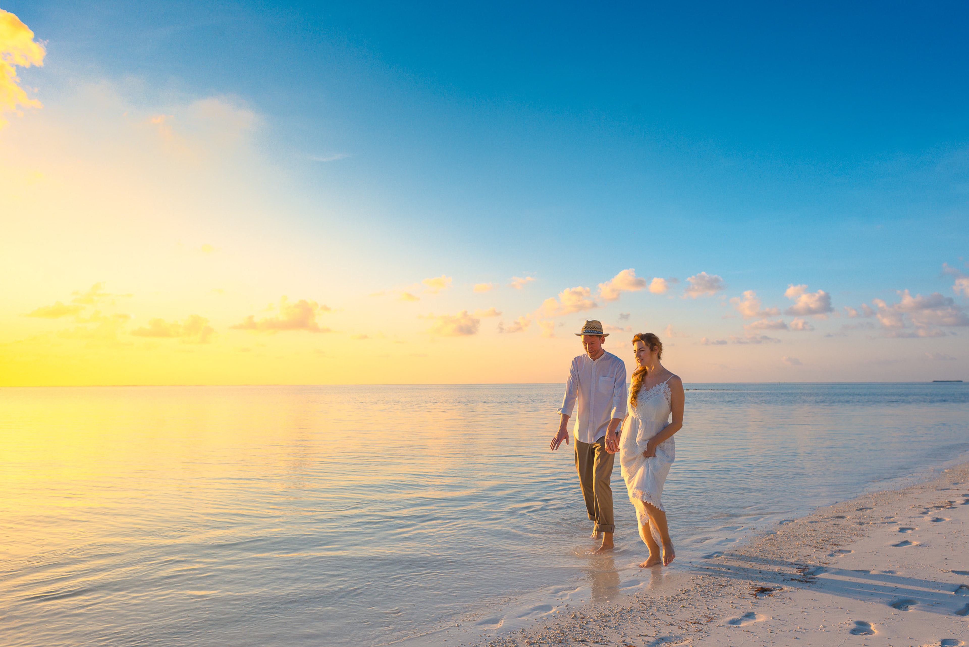 A photograph of a couple on the beach