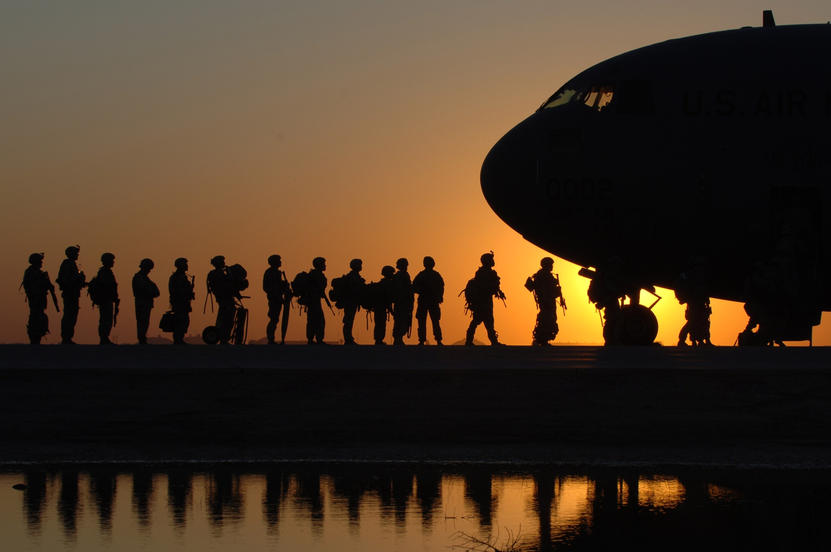 A photograph of soldiers boarding a plane